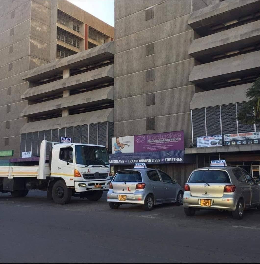 Series Driving School cars and truck parked in the city
